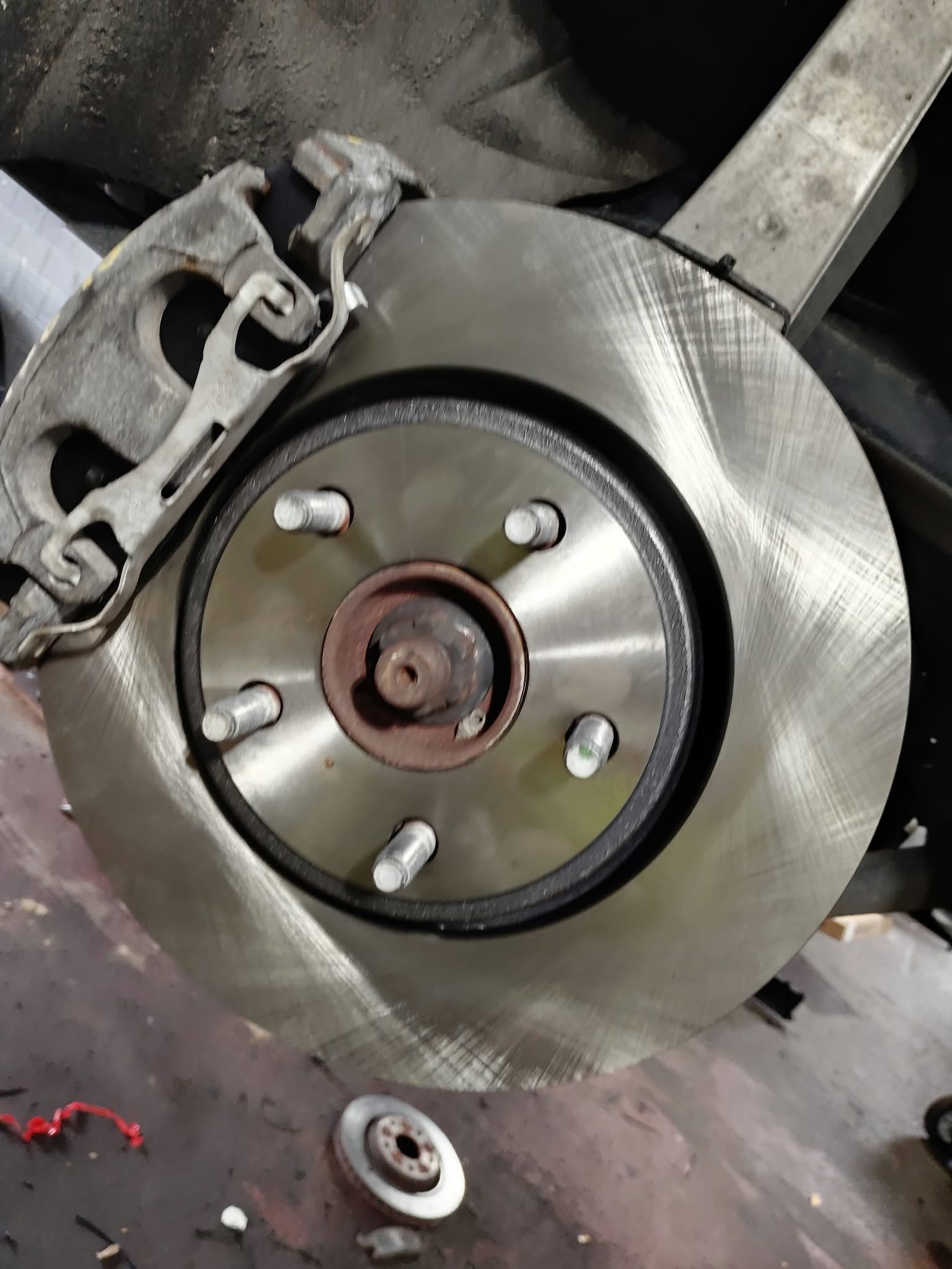 Fresh brake rotor and caliper after repair